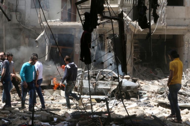 People inspect the damage at a site hit by airstrikes, in the rebel-held area of Aleppo''s Bustan al-Qasr