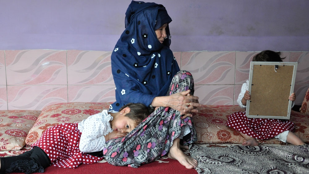 Basira's mother, centre, now helps her daughter raise her children [Fatima Faizi/ Al Jazeera] 