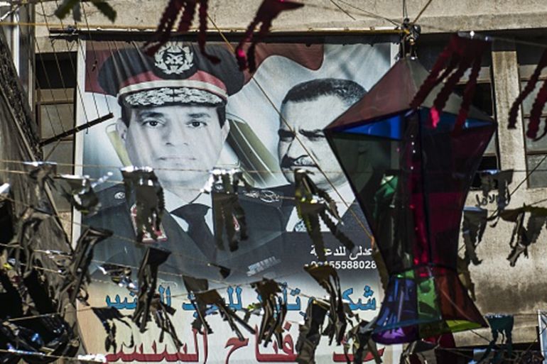 Portraits of Egyptian President Abdel Fattah el-Sisi and late president Gamal Abdel Nasser are seen on a wall in Cairo [Getty]