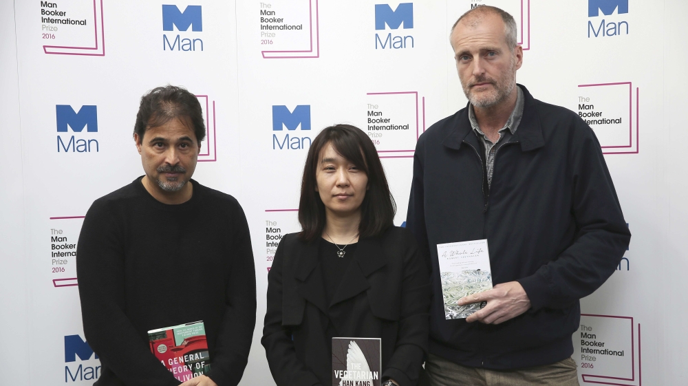 Nominated authors, from left to right, Jose Eduardo Agualusa, Han Kang and Robert Seethaler pose with their novels [Reuters]