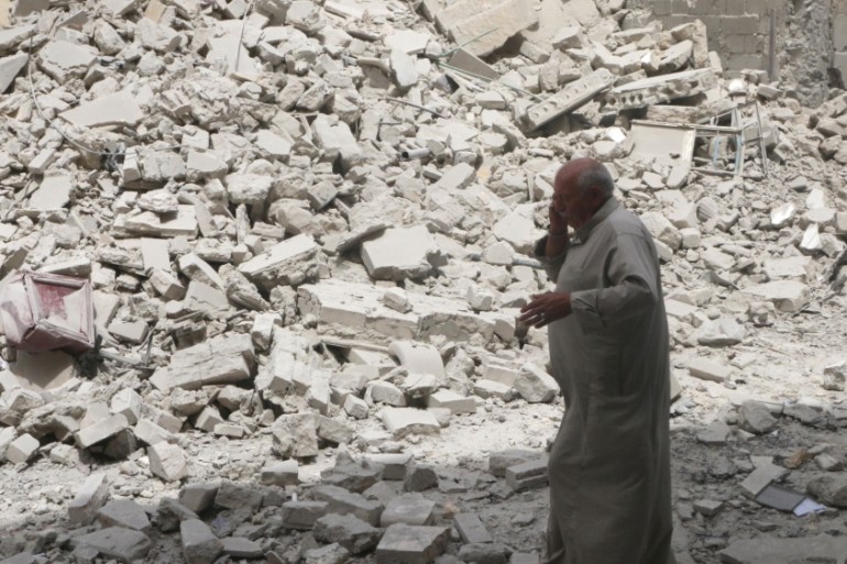 A man walks past the rubble of damaged buildings after an airstrike in the rebel held area of Aleppo''s Baedeen district