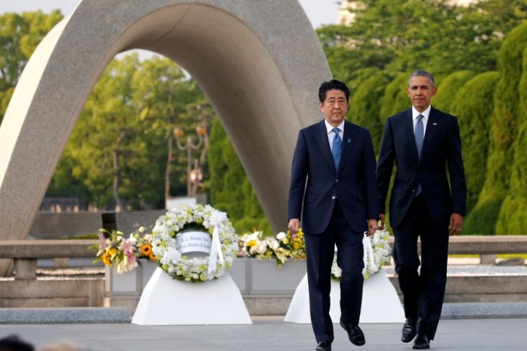 U.S. President Barack Obama and Japanese Prime Minister Shinzo Abe walk in front of a cenotaph after they laid wreaths at Hiroshima Peace Memorial Park in Hiroshima, Japan