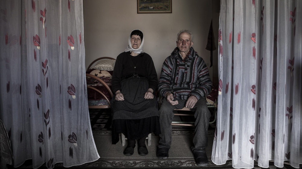 Maria Chosaj and her husband. Seventy-year-old Maria says she is not looking for revenge for the death of her son but neither has she accepted an offer of peace from the family of his killer. As a result, her grandchildren may avenge their father’s murder [Carlo Gianferro/Al Jazeera] 