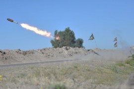 Iraqi fighters fire a rocket toward ISIL positions on the outskirts of Fallujah, west of Baghdad [REUTERS]