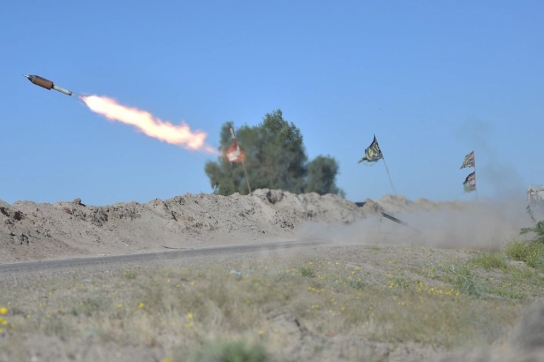 Iraqi fighters fire a rocket toward ISIL positions on the outskirts of Fallujah, west of Baghdad [REUTERS]