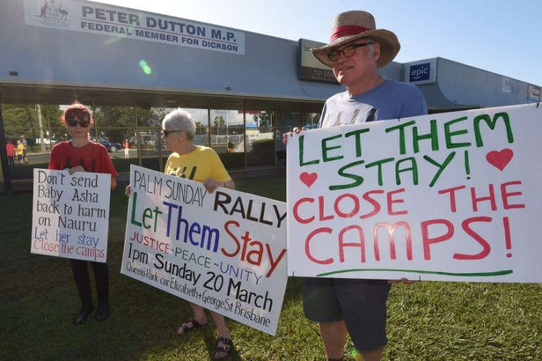 Refugee activists protest outside the electoral office of Australian Immigration Minister Peter Dutton in Brisbane