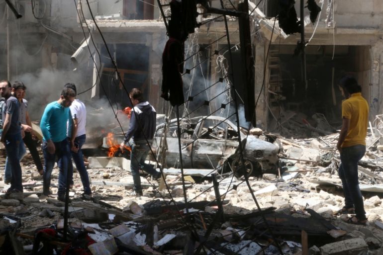 People inspect the damage at a site hit by airstrikes, in the rebel-held area of Aleppo''s Bustan al-Qasr