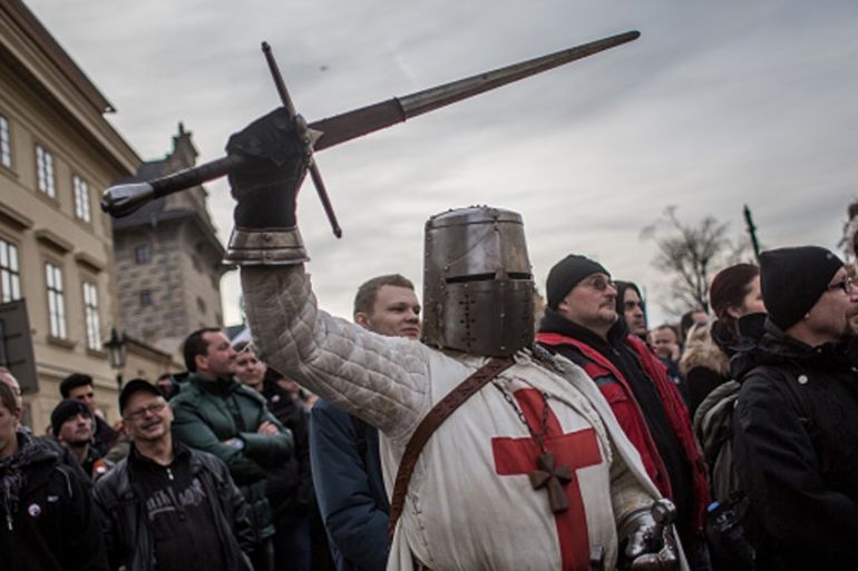 A participant dressed as Crusader holds a sword during an anti-Islam protest in Prague, Czech Republic [Getty]