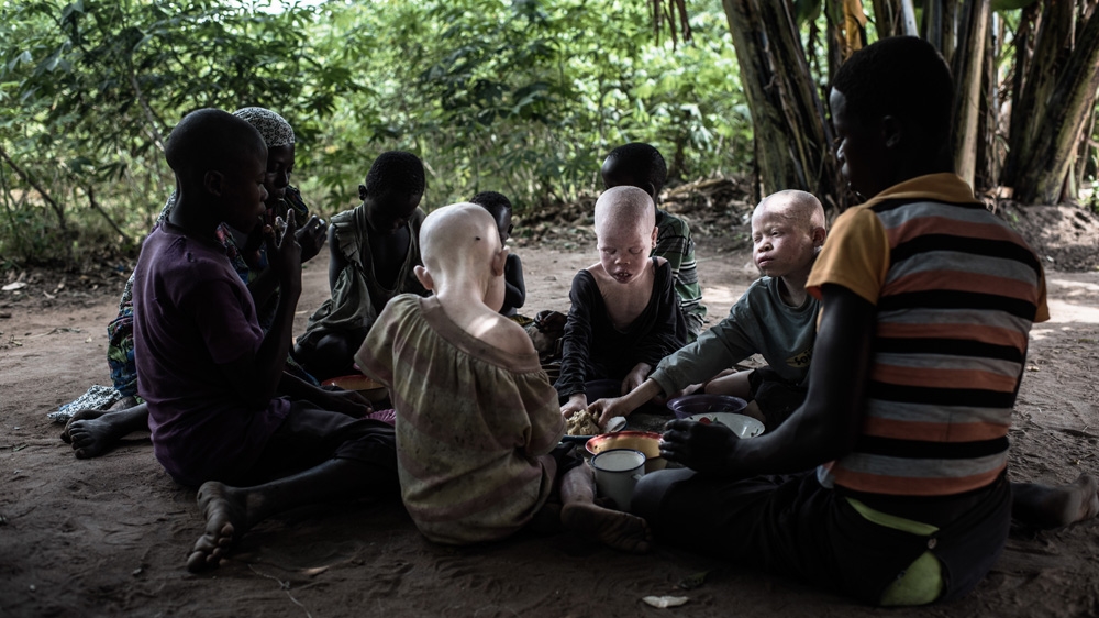 The children have dinner together with some of their friends from the village. They don't see any difference in each other - they all play and eat together [Fredrik Lerneryd/Al Jazeera]