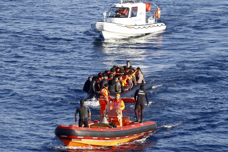 File photo of a Turkish Coast Guard fast rigid-hulled inflatable boat tows a dinghy filled with refugees and migrants in the Turkish territorial waters of the North Aegean Sea