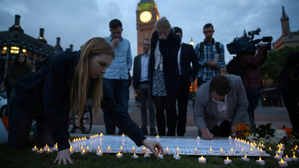  Dozens gathered outside the Houses of Parliament in a vigil to remember Cox [Neil Hall/Reuters]