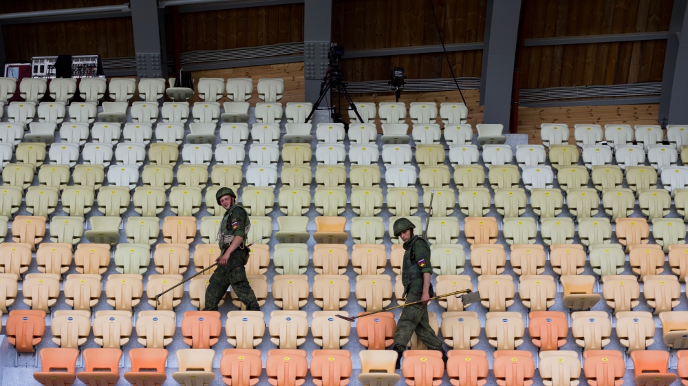 Russian soldiers check the Sukhumi stadium for explosive devices [Nathaniel White/Al Jazeera] 