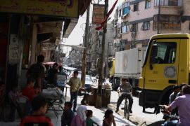Syrians gather around Syrian Arab Red Crescent truck bringing aid to Douma, Syria [EPA]