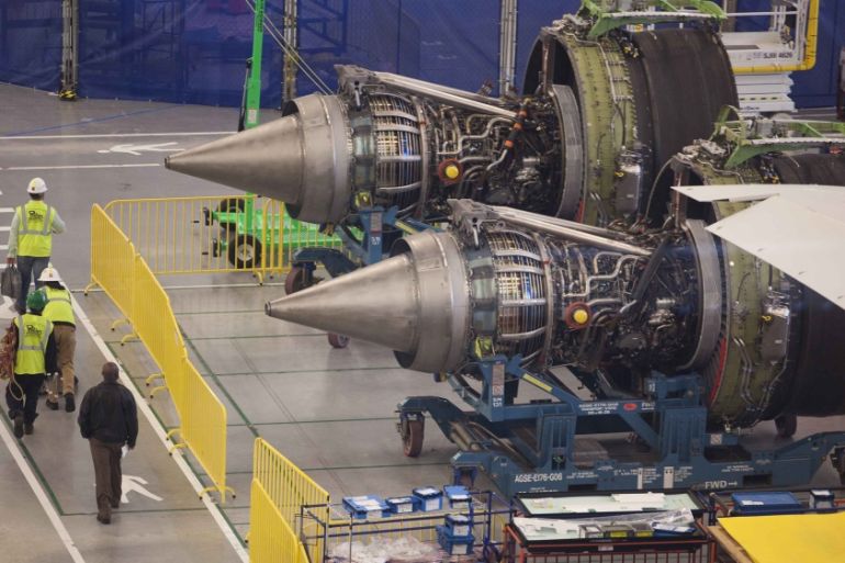Workers at South Carolina Boeing walk past the engines of a 787 Dreamliner being made for Air India at the plant''s final assembly building in North Charleston