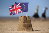 The flag of the European Union and the Union flag sit on top of a sandcastle on a beach in Southport, United Kingdom [Getty]