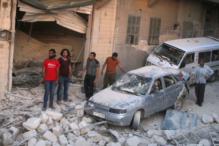 Men inspect damage after an airstrike on Aleppo''s rebel held al-Hallak neighbourhood