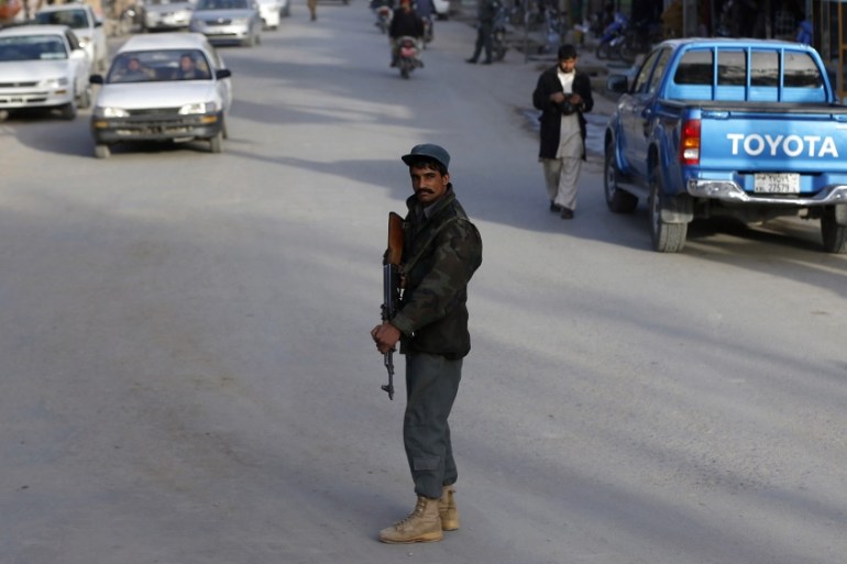 Afghan policeman keeps watch at a checkpoint in Farah province