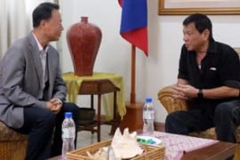 Filipino President-elect Rodrigo Duterte talking to Chinese envoy Zhang Jianhua during a meeting in Davao City.