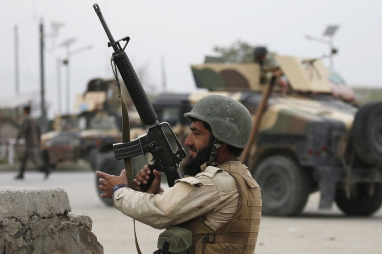 Afghan National Army (ANA) soldier takes up position at the site of a suicide car bomb attack in Kabul, Afghanistan