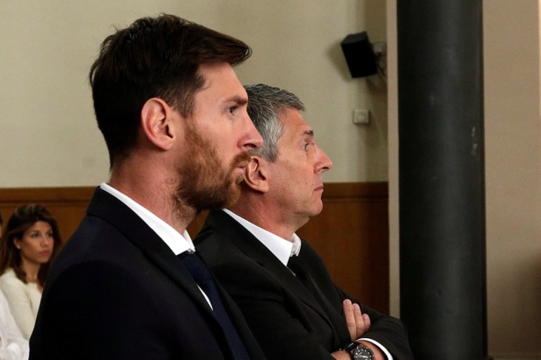 Barcelona''s Argentine soccer player Lionel Messi sits in court with his father Jorge Horacio Messi during their trial for tax fraud in Barcelona