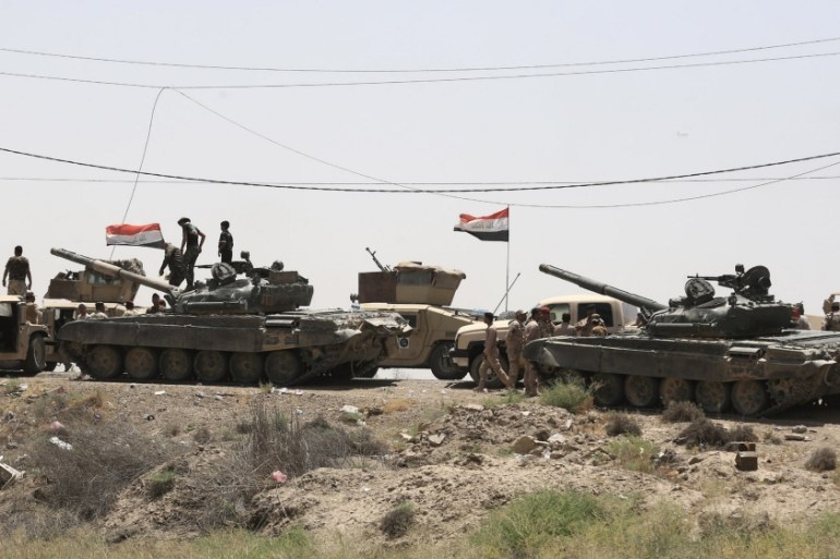 Military vehicles of the Iraqi security forces are seen in Saqlawiya