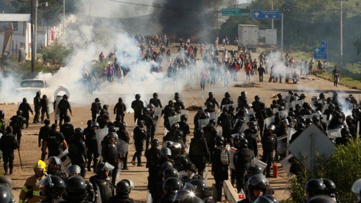 Protesters from the National Coordination of Education Workers (CNTE) teachers’ union clash with riot police officers during a protest, in Nochixtlan