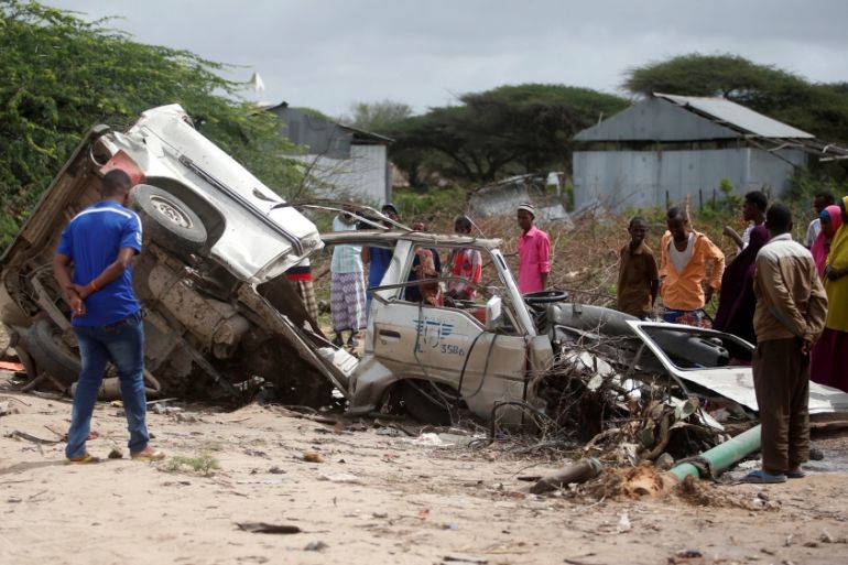 Residents gather to look at the wreckage of a minibus destroyed in roadside bomb in Lafoole village near Somalia''s capital Mogadishu