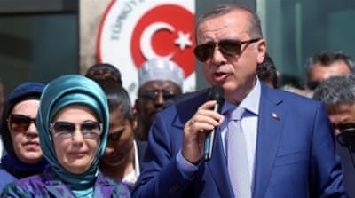 Turkish President Tayyip Erdogan flanked by his wife Emine Erdogan [Reuters]