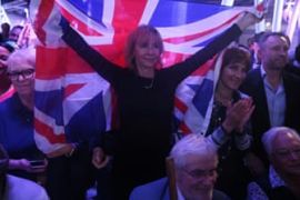 A Brexit supporter holds a Union Flag at a Vote Leave rally in London