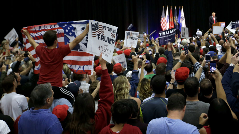 Supporters watch as Republican presidential candidate Donald Trump arrives during a rally in California [Chris Carlson/AP]