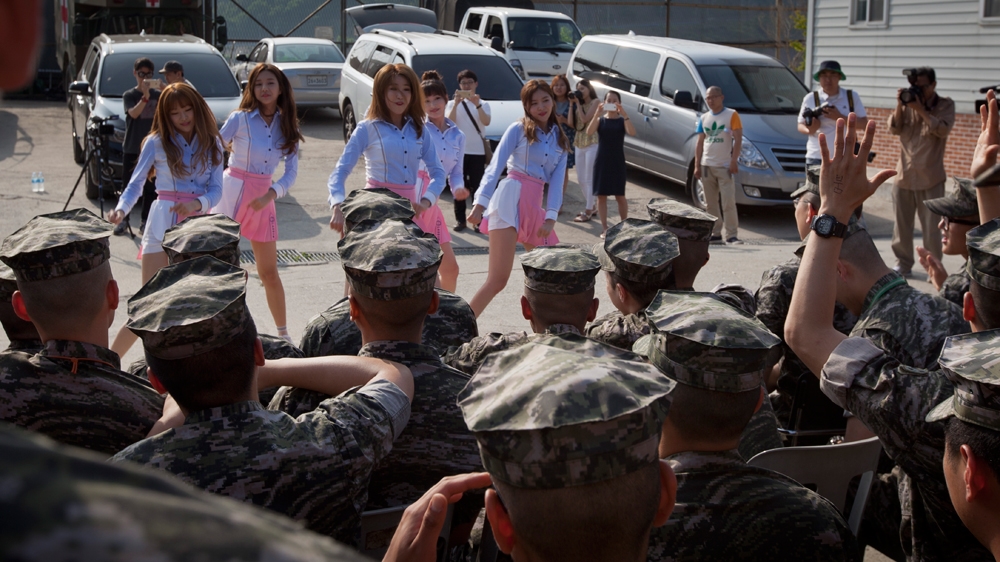 Marines fervently react to a performance by K-pop band La Boum as it tours bases across the country to boost morale [Joel Lawrence/Al Jazeera]