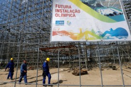 Workers are pictured at the construction site of the beach volleyball venue for 2016 Rio Olympics on Copacabana beach in Rio de Janeiro