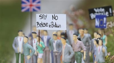 Mini demonstrators for Brexit are seen in front of a miniature of British Parliament in Mini-Europe miniature park in Brussels, Belgium [Olivier Hoslet/EPA]