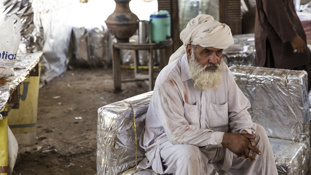 Dawood from Quetta joined Gul Bahao a couple of years ago and can make as many as 10 to 12 chairs a day [Faras Ghani/Al Jazeera]