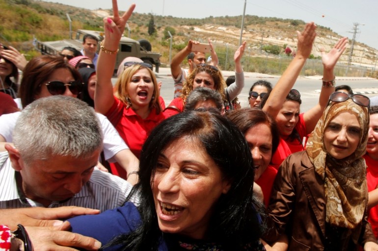 Palestinian lawmaker Khalida Jarrar is welcomed by Palestinian activists following her release from an Israeli jail at Israeli Jbara checkpoint near the West Bank city of Tulkarm