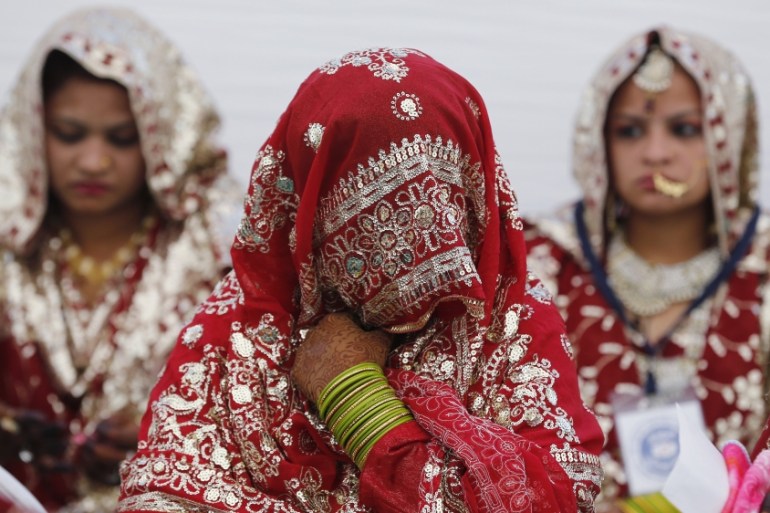 Muslim brides wait for the start of a mass marriage ceremony in Ahmedabad
