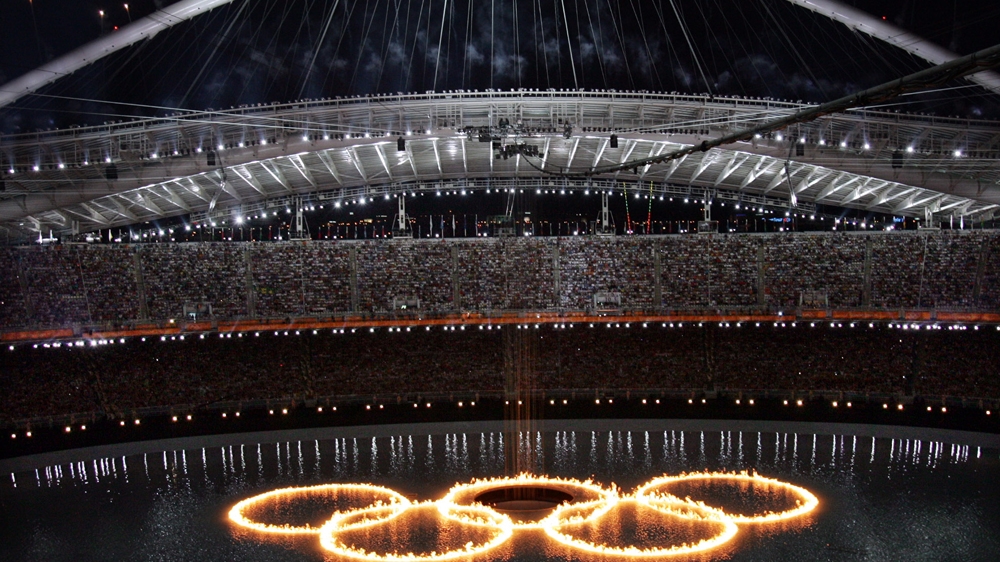 The Olympic Rings are shown in flames during the opening ceremony of the 2004 Olympic Games in Athens [David J. Phillip/AP] 