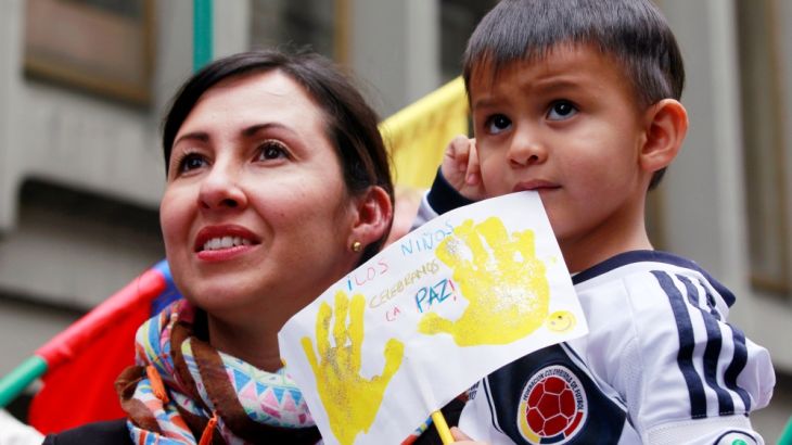 A woman and her son celebrate the signing of a historic ceasefire deal between the Colombian government and FARC rebels in Bogota