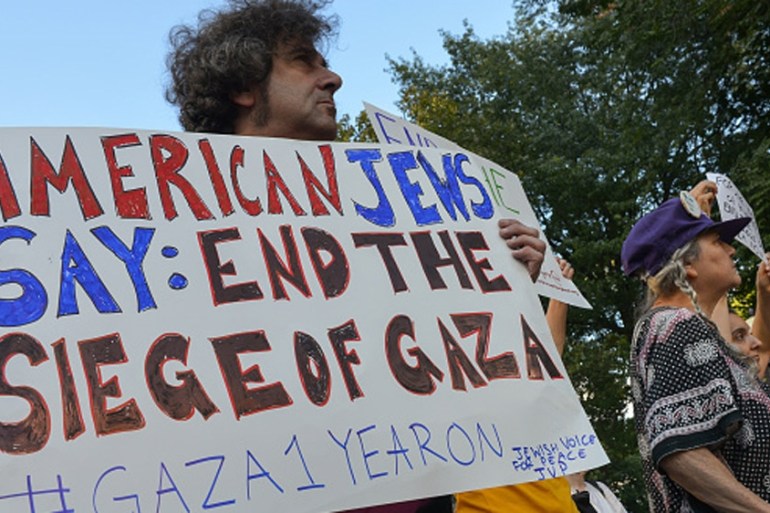 A protester holds a handmade sign at the concluding rally in Columbus Circle, demanding an end to US support for Israel [Getty]