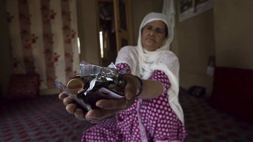 Hafiza must take six types of tablets a day for her medical problems, but the family says they can no longer afford the medication she needs to treat her depression [Baba Tamim/Al Jazeera]