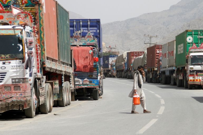 Transit trucks stranded due to the border skirmishes between Pakistan and Afghanistan are parked on the side of the road leading to the border in Torkham