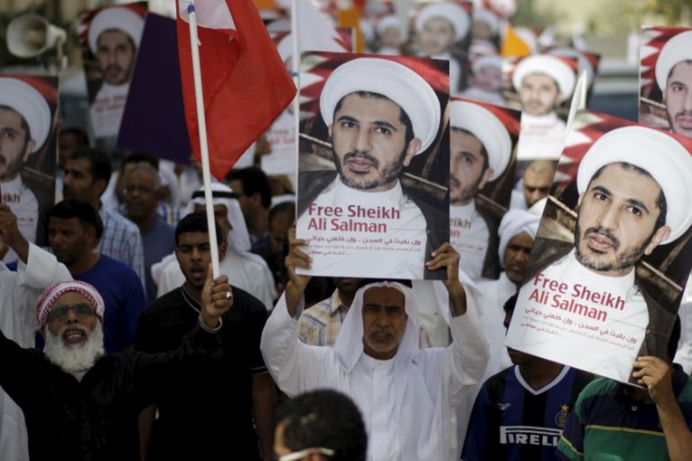 Protesters hold placards depicting photos of opposition leader and head of al-Wefaq party Sheikh Ali Salman during a protest after Friday prayers in the village of Diraz