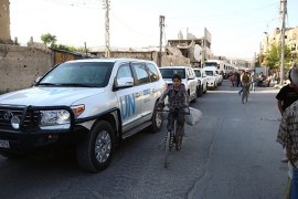 Vehicles of a UN and SARC aid convoy, with food, nutrition, health and other emergency items, enter the rebel-held town of Douma, east of the Syrian capital Damascus [AFP]