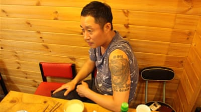 Diver Kim Sang-ho has afternoon food and drinks at a restaurant at Seoul's Gangnam district [Steven Borowiec/Al Jazeera]