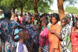 Women displaced in recent fighting queue to receive relief supplies as they camp at the Kator Catholic cathedral compound in Juba, South Sudan
