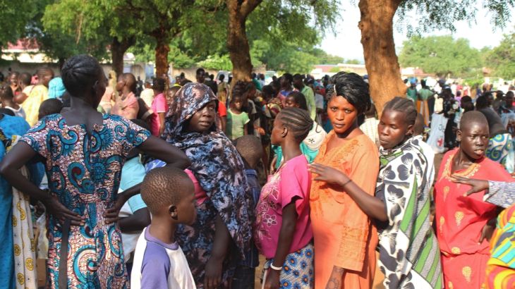 Women displaced in recent fighting queue to receive relief supplies as they camp at the Kator Catholic cathedral compound in Juba, South Sudan