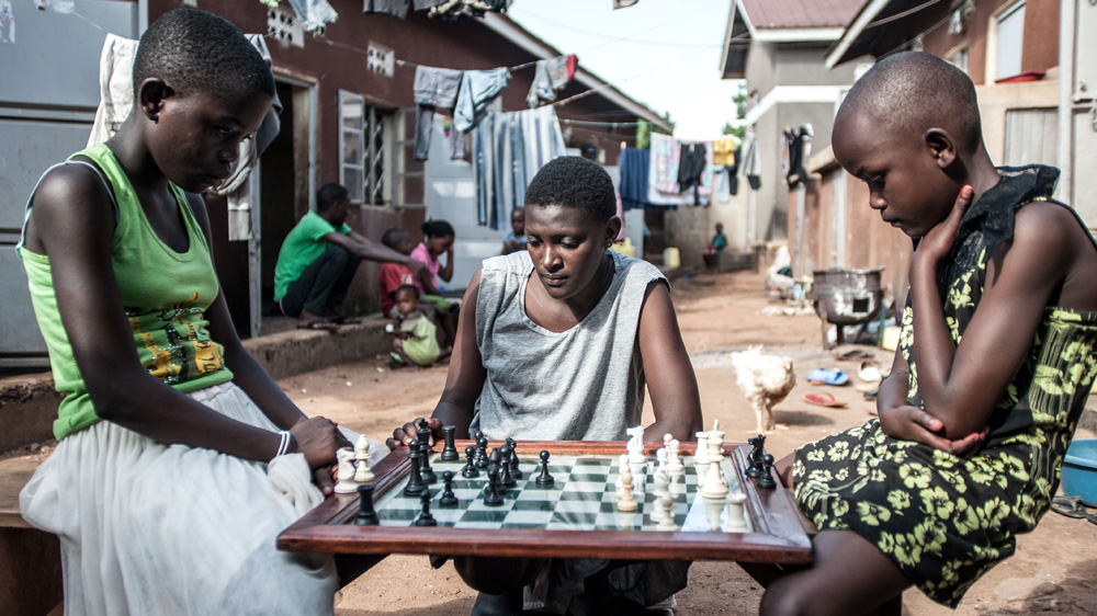 Lillian Asaba takes her opponent's Queen during a session at the Katwe Chess Academy [Aurelie Marrier d'Unienville/Al Jazeera]