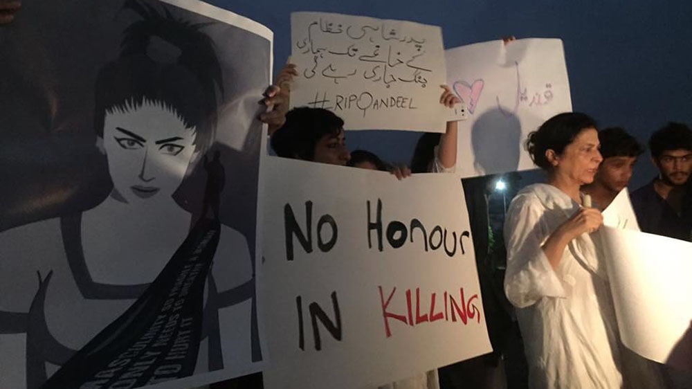 
'No honour in killing', read one of the placards at the Lahore vigil for Qandeel Baloch [Alia Chughtai/Al Jazeera]

