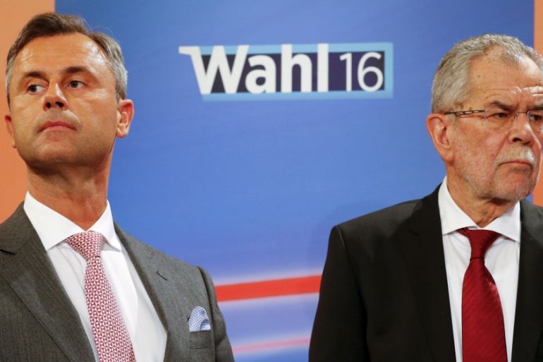 Presidential candidates Van der Bellen and Hofer react during a TV debate in Vienna