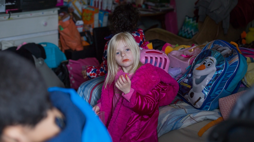  The motel room five-year-old Sofiya shares with her mother and father is cramped and strewn with toys, but it is home and Sofiya and her half brother Colby do not seem to see their lives as any different from those of their peers at school [Carolyn Bick/Al Jazeera] 
